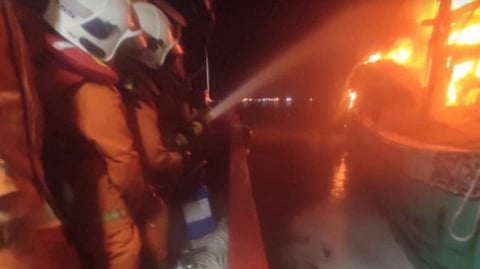 Firefighters work to extinguish the blaze on a trawler off Pantai Remis in Malaysia's Perak state, September 7, 2025.