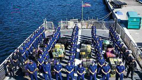 The crew of USCGC Seneca (WMEC 906) stand for a photo during a drug offload at Port Everglades in Fort Lauderdale, Florida, Sept. 30, 2025. The crew offloaded more than 12,750 pounds of cocaine and marijuana with an approximate street value of $94.5 million.