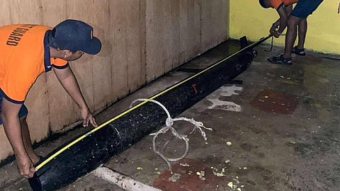 Philippine Coast Guard personnel measuring the recovered UUV
