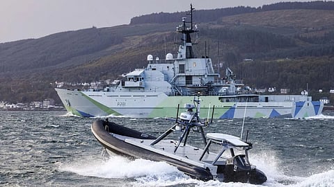 A 7.2-metre USV escorting the offshore patrol vessel HMS Tyne during trials