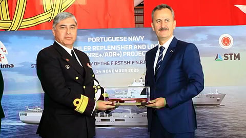 Dr Haluk Görgün (right), President of the Turkish Defence Industry Agency, presents a scale model of an auxiliary oiler replenisher and logistics ship (AOR+) to Rear Admiral Marques da Costa, Director of Ships for the Portuguese Navy, during the AOR+ vessels' steel-cutting ceremony, November 14, 2025.