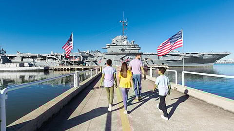 Visitors walk towards the preserved ex-US Navy aircraft carrier USS Yorktown at the Patriots Point Naval and Maritime Museum in Charleston Harbor, South Carolina.