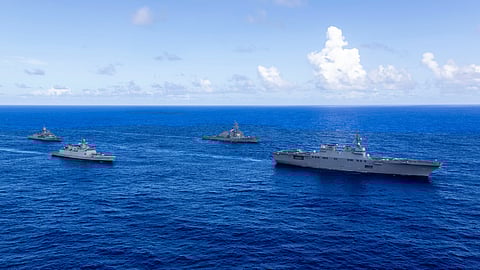 The Japan Maritime Self-Defence Force helicopter carrier JS Hyuga leads the US Navy guided-missile destroyer USS Fitzgerald, the Indian Navy stealth frigate INS Sahyadri, and the Royal Australian Navy frigate HMAS Ballarat during Exercise Malabar 2025 off the coast of Guam.