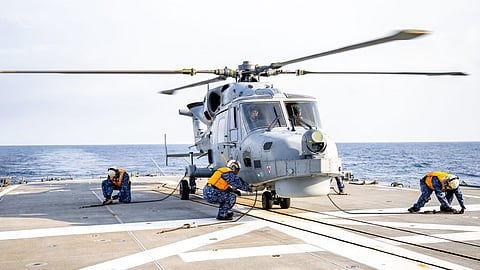 A Philippine Navy AW159 Wildcat helicopter is secured aboard the flight deck of the Japan Maritime Self-Defence Force destroyer JS Harusame during a maritime cooperative activity in the South China Sea, November 29, 2025.