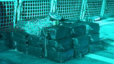 Thirty-three bales of contraband sit on the US Coast Guard cutter USCGC Active’s flight deck from an interdiction of a suspected drug smuggling vessel while patrolling the Eastern Pacific Ocean, November 25, 2025. Active’s crew seized more than 3,300 pounds of cocaine and detained three suspected drug smugglers during the operation.