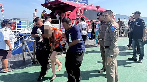 Rescuers assist one of the survivors of the collision between the tour boat Korawich Marine 888 and the trawler Pichai Samut 1 off Thailand's Phi Phi Islands on January 11, 2026. The incident left one Russian passenger dead while 21 other people suffered injuries.