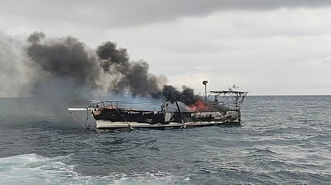 The burning sailing yacht Allusive off the coast of Batangas province in the Philippines, January 27, 2026. All seven of the vessel's crew were rescued unharmed.