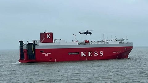 A helicopter hovers above the pure car and truck carrier Thames Highway shortly after delivering firefighters to the ship in the Wadden Sea off Germany, January 27, 2026. The ship suffered an onboard fire the night before and became disabled, though no injuries or oil spills have been reported.