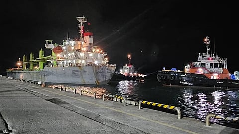 Two tugs manoeuvre alongside the bulk carrier CSE Prosperity Express at Taiwan's Hualien Port, January 1, 2017. Earlier on the same date, the bulk carrier ran aground in bad weather while approaching the port.