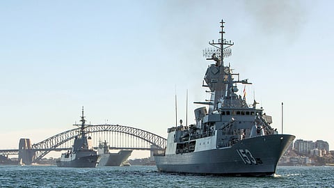 Royal Australian Navy ships depart Sydney to conduct a series of exercises. Nearest to farthest: the Anzac-class frigate HMAS Stuart, the Hobart-class destroyer HMAS Hobart, and the Canberra-class landing helicopter dock HMAS Canberra