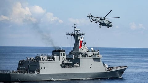 A Philippine Navy AW159 Wildcat anti-submarine warfare helicopter flies alongside the guided missile frigate BRP Antonio Luna during a maritime sovereignty patrol off the western Philippines, June 27, 2023.