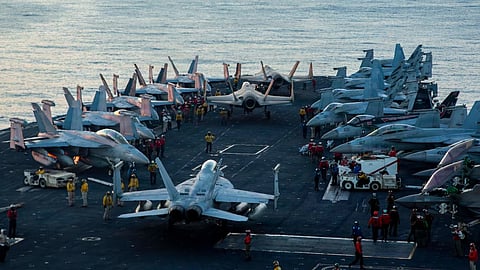US sailors taxi aircraft to a staging point on the flight deck of Nimitz-class aircraft carrier USS Abraham Lincoln (CVN 72) in support of Operation Epic Fury, February 28, 2026