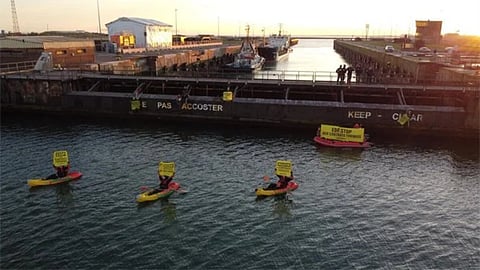 Greenpeace protesters on small boats attempt to prevent the cargo ship Mikhail Dudin from docking at the Port of Dunkirk in France, March 2, 2026. The protesters have alleged that the ship was transporting uranium from Russia.