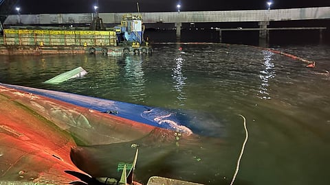 The capsized cargo ship Theresa I at the APO Cement Port in Naga City, Cebu province, Philippines, March 11, 2026