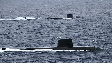 An unidentified Japan Marine Self-Defence Force submarine (foreground) and the US Navy Los Angeles-class attack submarine USS Santa Fe underway