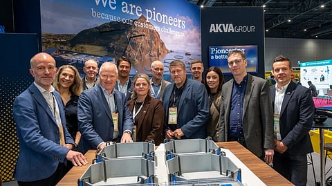 Laxey and Akva representatives with a scale model of the smolt station interior