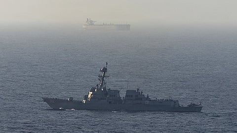 A US Navy warship with an unnamed tanker in the background