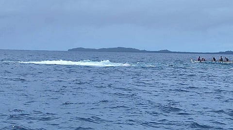 Philippine Coast Guard personnel on a small boat in the area where the cargo vessel LCT Pacifica 3 capsized and broke into two pieces off Surigao del Norte province, April 30, 2026