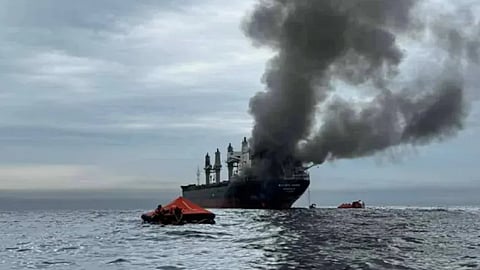 Smoke billows from the Thai-flagged bulk carrier Mayuree Naree after it was struck by a projectile off the coast of Oman, March 11, 2026.
