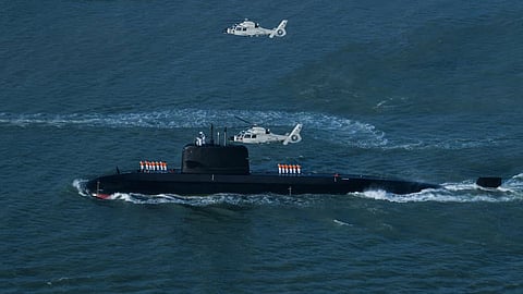 The Pakistan Navy submarine PNS Hangor being escorted by small boats and Z-9EC helicopters as she nears Karachi, June 11, 2026