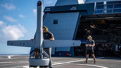 Contractors prepare to launch a Shield AI VTOL UAV for first flight onboard the UUS Navy Zumwalt-class guided-missile destroyer USS Michael Monsoor during Exercise Rim of the Pacific, July 13, 2022.