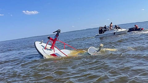 The capsized fireboat with the Carteret Fire Department crew being rescued nearby, July 4, 2026
