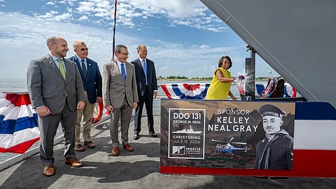 Kelley Neal Gray smashes the ceremonial bottle against the hull of the ship named after her late father, Petty Officer Third Class George M. Neal, at Ingalls Shipbuilding's facilities in Pascagoula, Mississippi, July 11, 2026. The future USS George M. Neal is being built as a flight III Arleigh Burke-class guided-missile destroyer with enhanced air and missile defence capabilities.