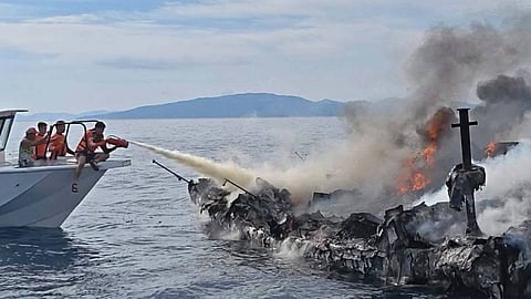 Philippine Coast Guard personnel work to contain the blaze on the motor yacht Jason off the Philippines' Romblon province, July 19, 2026.