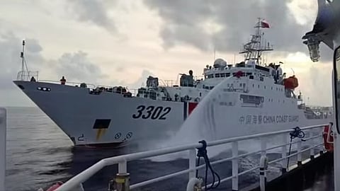 Screenshot of video showing a China Coast Guard vessel firing a water cannon at a Philippine fisheries vessel, July 23, 2026.