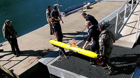 Personnel prepare to deploy a Royal Navy autonomous underwater vehicle as part of the joint UK-US-Australian Exercise Lanternfish.