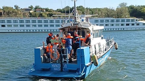 A Bulgarian Border Police boat evacuates some of the passengers from the river cruise ship Viking Ullur after it ran aground on the Romanian side of the Danube River, July 28, 2026.