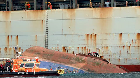 Korea Coast Guard personnel inspect the hull of the capsized tug TNS Catcher off Busan, September 2, 2026. Only one of the tug's eight-strong crew has been rescued while another individual is confirmed dead and six others are unaccounted for.