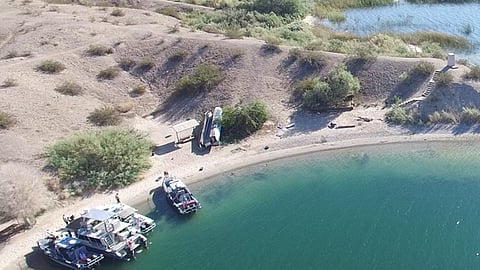 The overturned 36-foot catamaran on the shore of Lake Havasu in Arizona following the September 12, 2026, crash that killed its two occupants