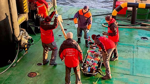 Rescuers attend to crewmember of stricken fishing vessel Triumph