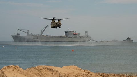 Ships and a US Army CH-47 Chinook helicopter off Joint Expeditionary Base Little Creek-Fort Story in Virginia Beach, Virginia