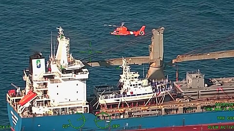 A US Coast Guard Air Station Barbers Point MH-65 Dolphin helicopter crew medevaced a man with a medical condition from a cargo ship 86 miles offshore Hawaii Oct. 7, 2026.