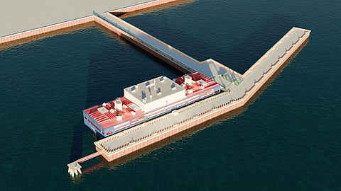 Diagram of a nuclear-powered vessel beside a long pier, with a smaller craft near the shore.