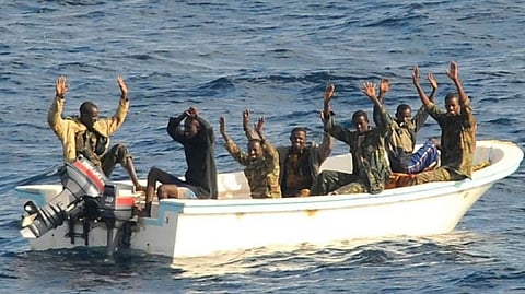 Suspected pirates await boarding of their vessel by US Navy personnel somewhere in the Gulf of Guinea.