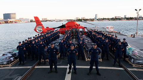 The crew of the US Coast Guard medium endurance cutter USCGC Tampa pose with seized contraband during a drug offload at Port Everglades, Florida, October 14, 2026. The crew offloaded approximately 29,600 pounds of cocaine and 3,355 pounds of marijuana, valued at an estimated US$226.7 million, resulting from six interdictions in international waters of the Eastern Pacific Ocean.