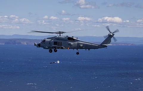 A Royal Australian Navy MH-60R Seahawk helicopter launches a sonobuoy during an anti-submarine warfare training in 2020 off the coast of Jervis Bay, New South Wales. (Photo: Australian Department of Defence/Nadav Harel)