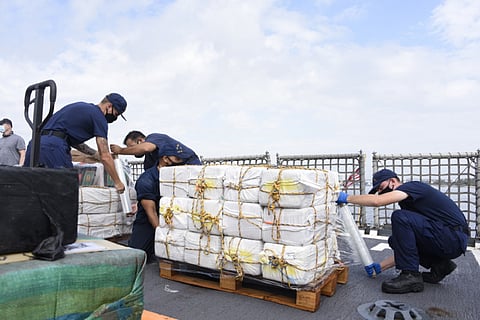 US Coast Guard personnel on the cutter Harriet Lane wrap bales of seized narcotics prior to offloading at Port Everglades, Florida, on February 8, 2021. (Photo: US Coast Guard/Petty Officer 3rd Class Jose Hernandez)