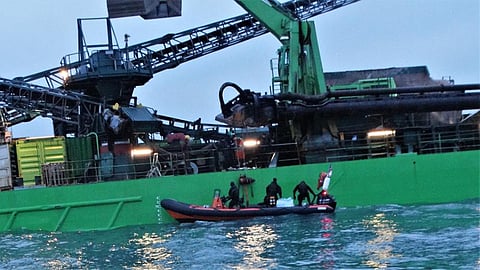 The unexploded projectile being lowered into the Royal Navy EOD RHIB (Photo: RNLI/Max Gilligan)