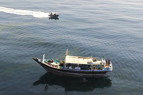 A boarding team from the French Navy frigate Jean Bart approach a suspicious dhow in the Arabian Sea, after witnessing the crew dumping cargo overboard. A search and recovery operation later uncovered over 2,960 kilograms of illegal narcotics. (Photo: French Navy)