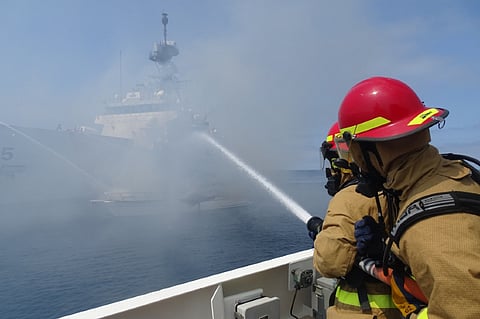 US Coast Guard cutter Benjamin Bottoms crewmembers work with the cutters Haddock and Munro to extinguish a vessel fire off the coast of San Diego, July 15, 2021. The vessel left the Oceanside harbor heading towards Carlsbad when it was seen on fire. (Photo: US Coast Guard/Petty Officer 1st Class Adam Stanton)