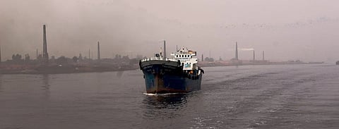 A cargo ship sailing through a river in Bangladesh