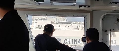 Philippine Coast Guard personnel aboard the multi-role response vessel BRP Malabrigo observe the close distance manoeuvring by a Chinese Coast Guard vessel just 19 metres away while both are underway in the waters of Scarborough Shoal, March 2, 2022. (Photo: Philippine Coast Guard)