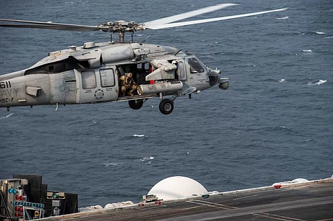 A US Navy MH-60S Seahawk helicopter from Helicopter Sea Combat Squadron Seven hovers above the flight deck of the aircraft carrier USS Dwight D. Eisenhower while in the US Fifth Fleet area of operations, December 24, 2023. (Photo: US Navy)