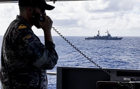 Lieutenant Vincent Bornaghi conducts an officer of the watch manoeuvres exercise from the bridge wing of HMAS Toowoomba with the Philippine Navy patrol ship BRP Gregorio del Pilar as part of the regional presence deployment on November 26, 2023. (Photo: Royal Australian Navy)