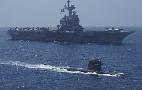 An Indian Navy Kalvari-class submarine sails alongside the French Navy aircraft carrier Charles de Gaulle during Varuna 2021, a series of bilateral exercises in the Indian Ocean held from April 25 to 27, 2021. (Photo: Indian Navy)