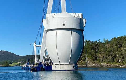 The Egget fish pen about to be lowered into the water at a fish farm. Only the topmost portion of the structure will remain above water. (Photo: Hauge Aqua)